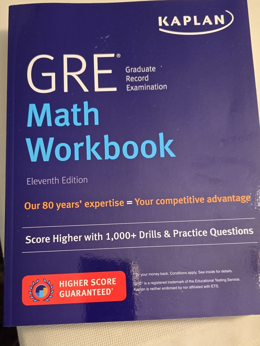 Kaplan GRE Math Workbook – Dark Blue Cover with Light Blue & Orange Accents